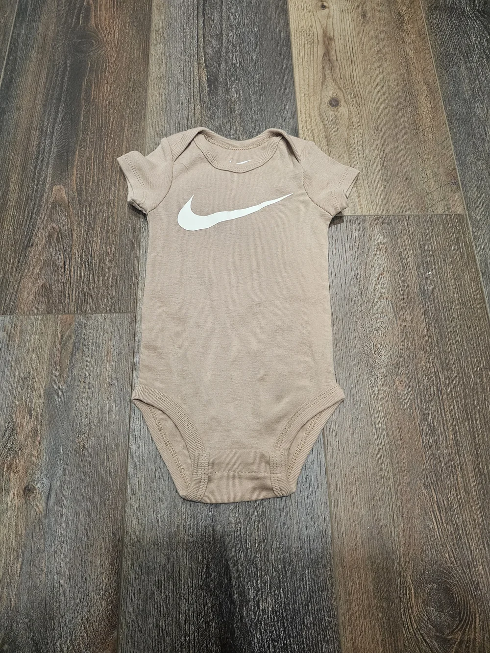 Nike Kids Beige One-Piece Bodysuit with White Swoosh